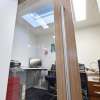 Large glass sliding doors of modular office in classroom